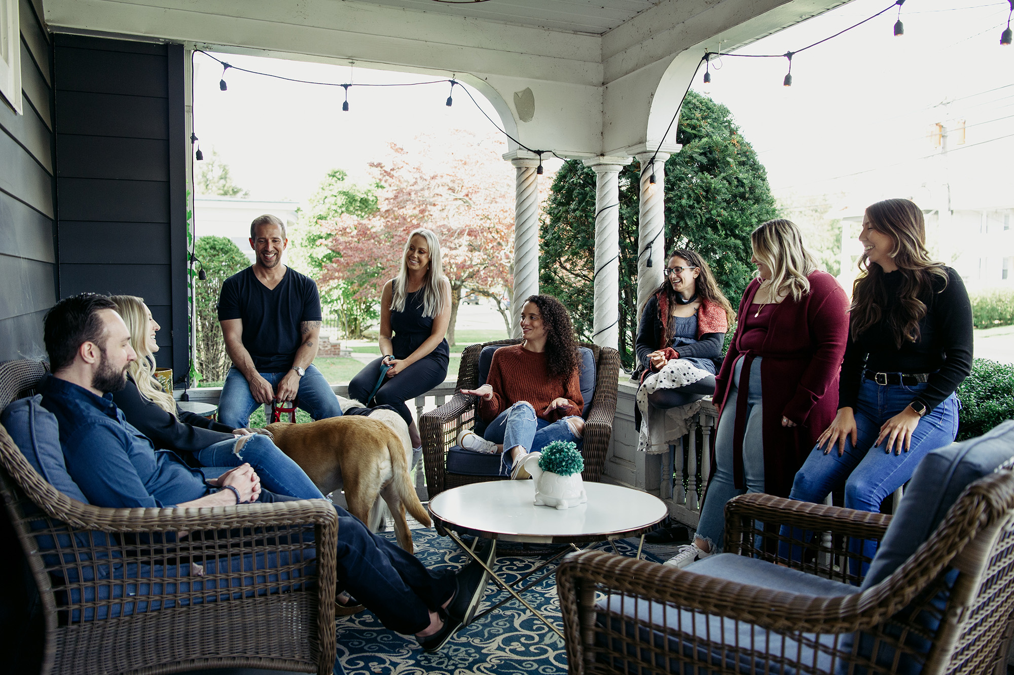 Blueprint Mental Health therapists on the front porch with a yellow labrador retriever, discussing parent support