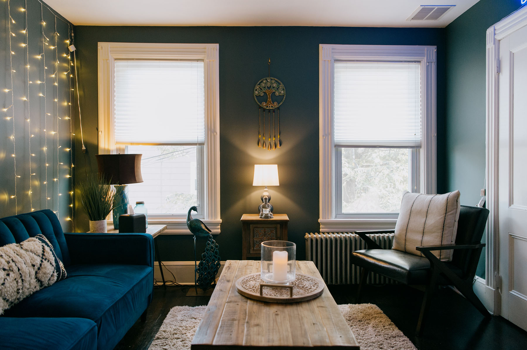 A welcoming view of Blueprint Mental Health's office, where you can find exceptional mental health treatment in NJ, featuring a blue couch and therapist’s chair.